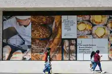 image displays a large-scale application of Contra Vision, also known as one-way vision window film or perforated window film